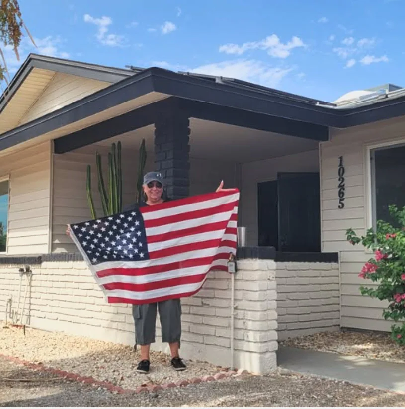 Holding the American flag in front of a Phoenix home.
